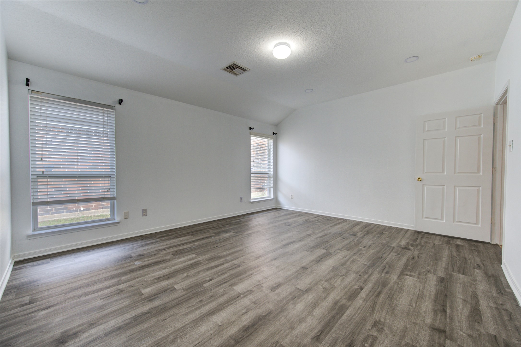 14315 Acorn Ridge Way Cypress, TX 77429 - Photo 14 of 22 an empty room with wooden floor and windows