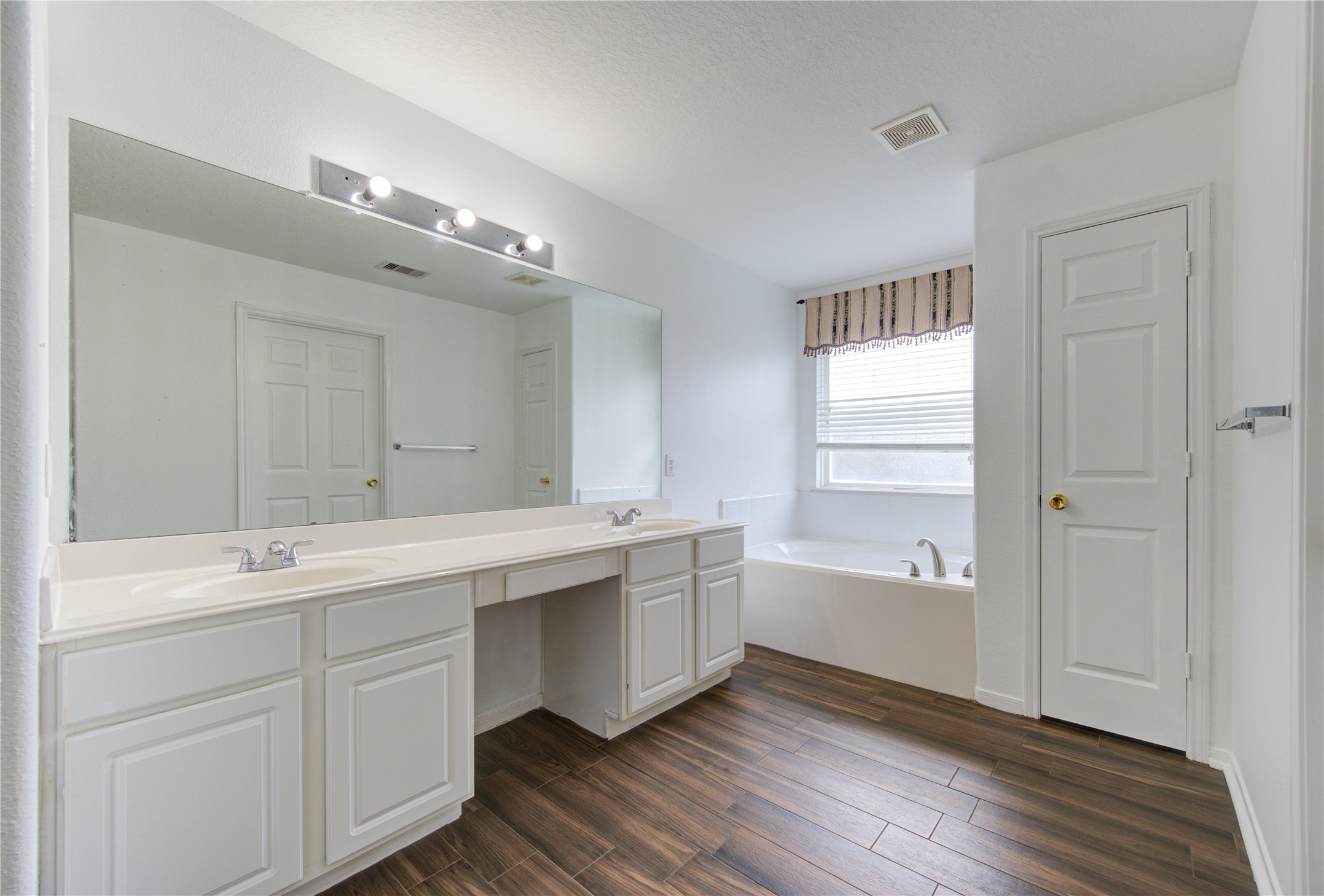 14315 Acorn Ridge Way Cypress, TX 77429 - Photo 16 of 22 a spacious bathroom with a double vanity sink a mirror and a bathtub