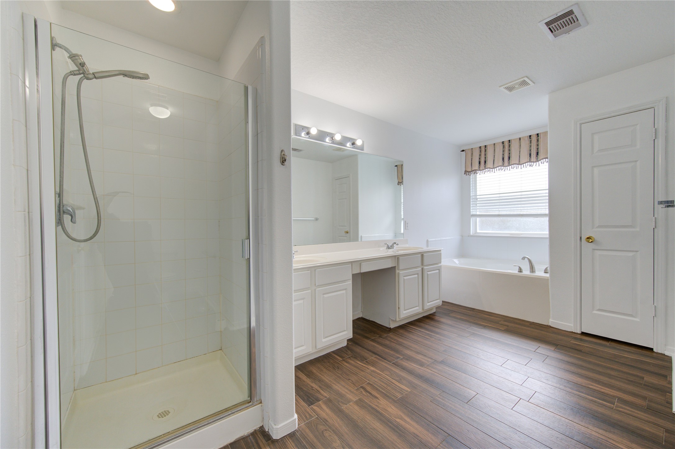14315 Acorn Ridge Way Cypress, TX 77429 - Photo 17 of 22 a bathroom with a double vanity sink mirror and shower