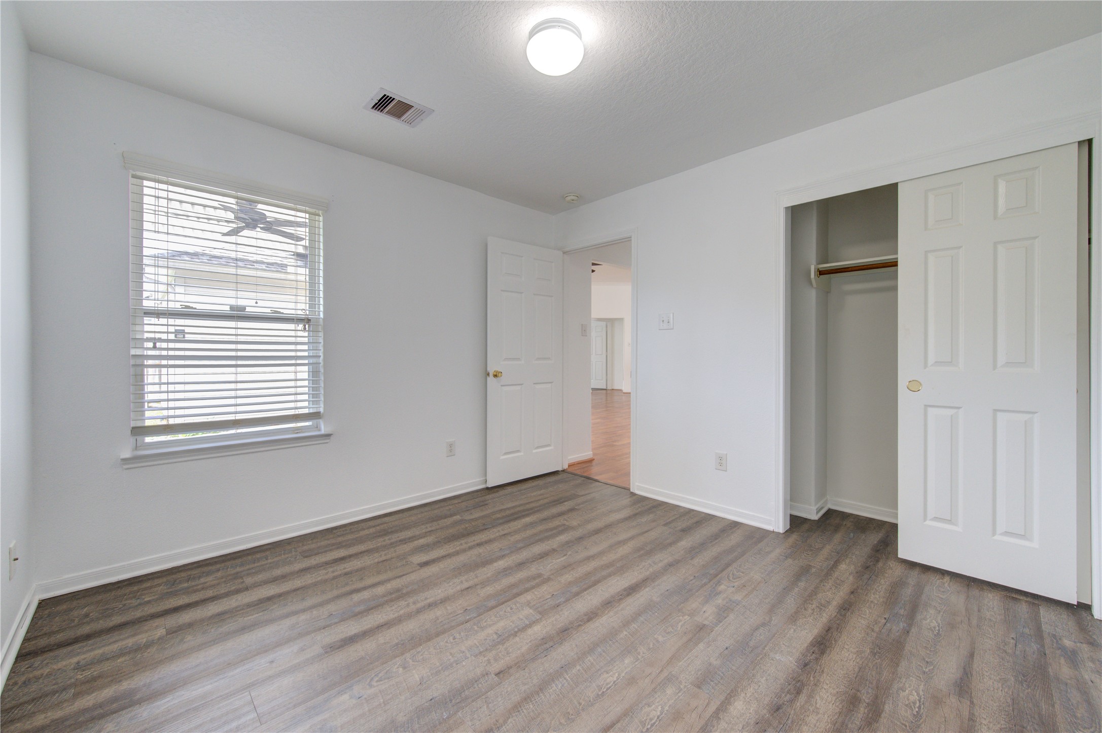 14315 Acorn Ridge Way Cypress, TX 77429 - Photo 18 of 22 a view of an empty room with wooden floor and a window