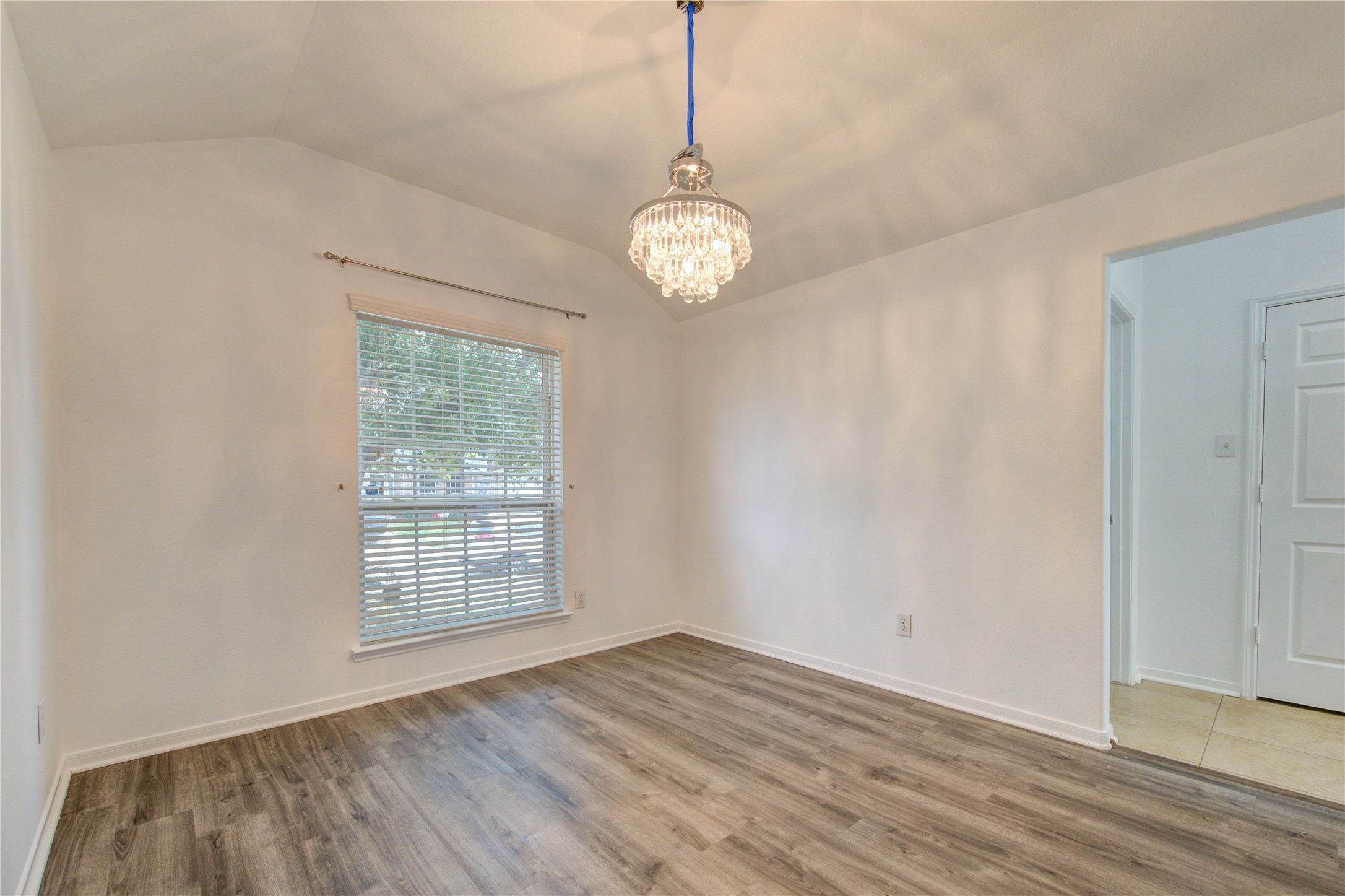 14315 Acorn Ridge Way Cypress, TX 77429 - Photo 5 of 22 a view of an empty room with wooden floor and a window
