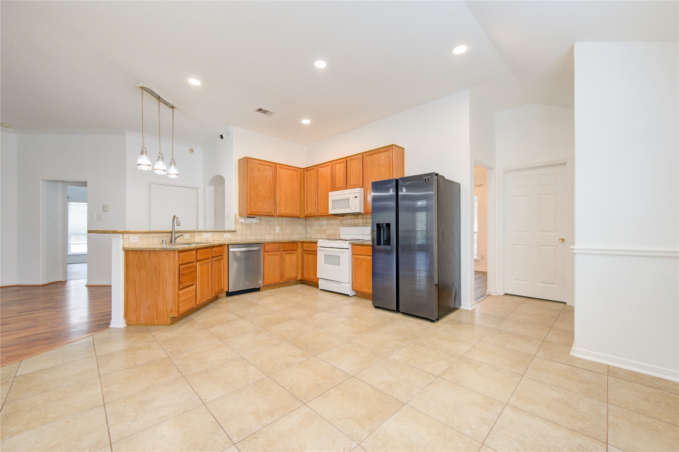 14315 Acorn Ridge Way Cypress, TX 77429 - Photo 9 of 22 a kitchen with stainless steel appliances a refrigerator and a sink