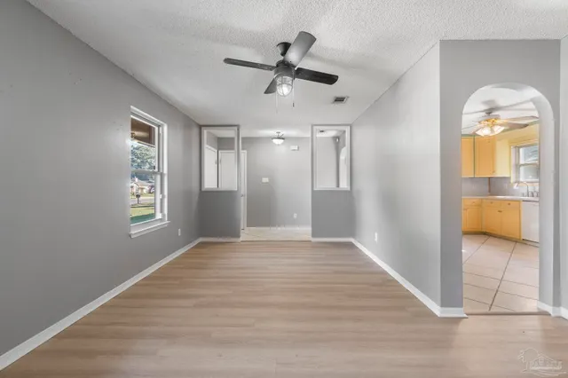 a kitchen with stainless steel appliances granite countertop white cabinets sink and a granite counter top