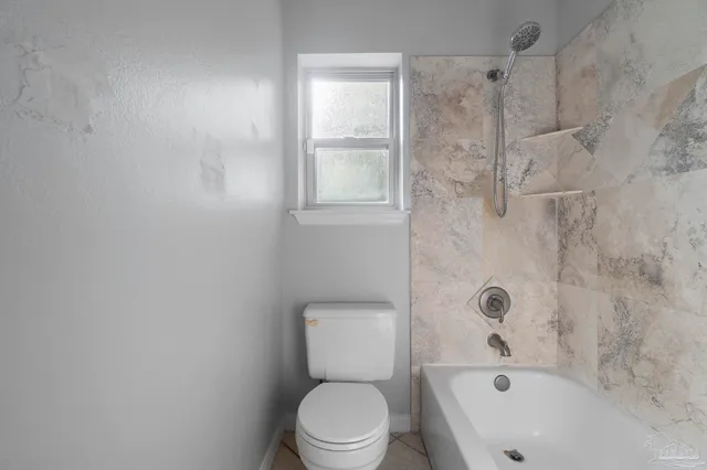 an empty room with fan and windows