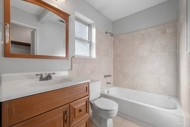 a backyard of a house with a small barn and wooden fence