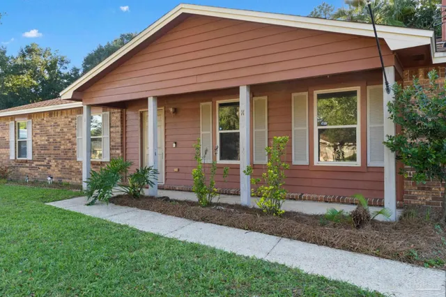 a front view of a house with garden