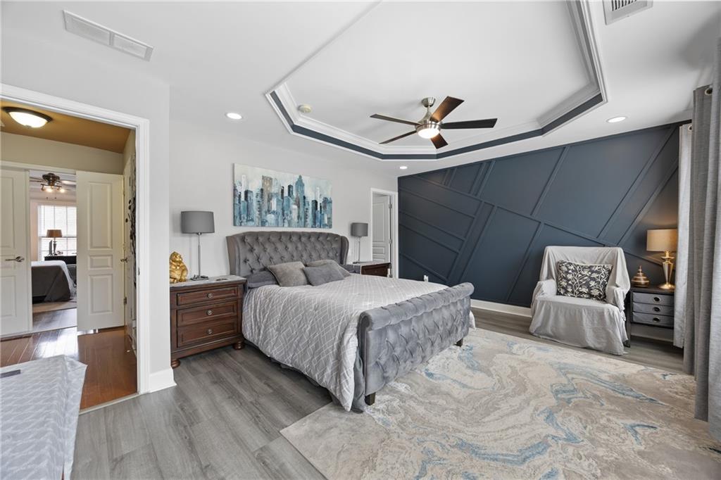 2871 Overlook Way Atlanta, GA 30324 - Photo 14 of 32 a spacious bedroom with a bed and a walk in closet