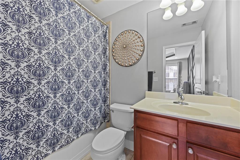 2871 Overlook Way Atlanta, GA 30324 - Photo 15 of 32 a bathroom with a toilet a sink and a mirror