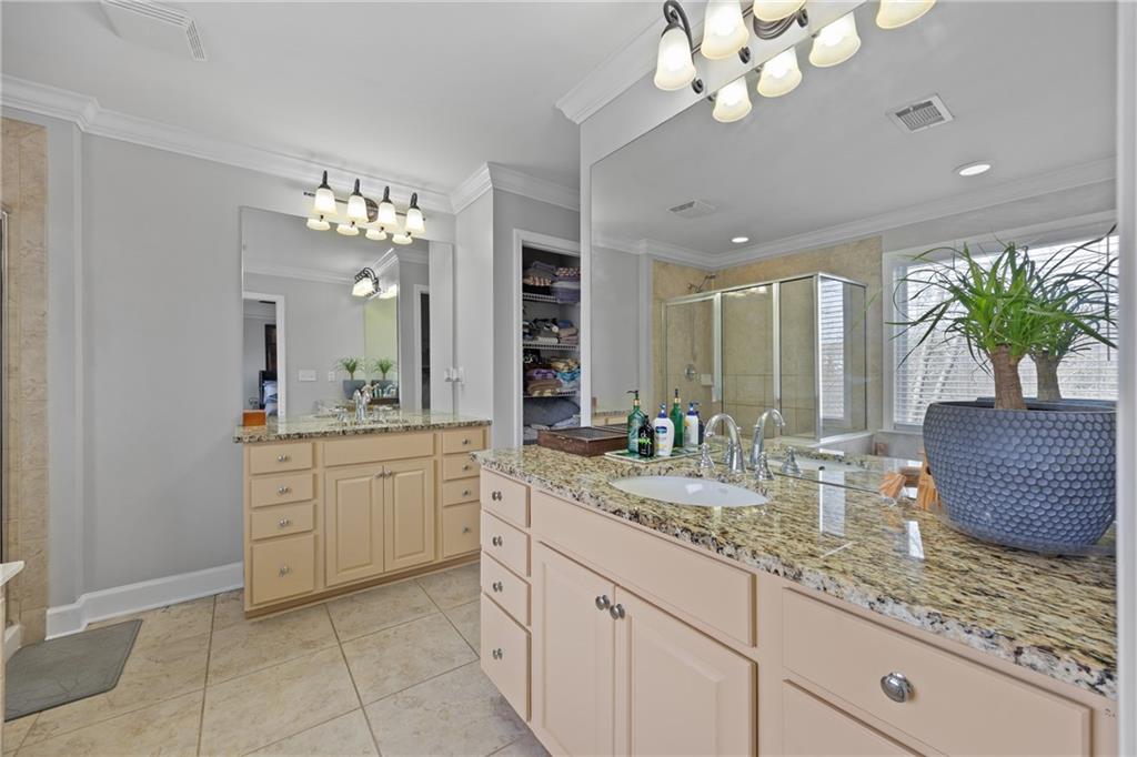 2871 Overlook Way Atlanta, GA 30324 - Photo 18 of 32 a bathroom with a granite countertop sink a large mirror and a shower