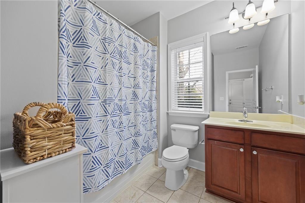 2871 Overlook Way Atlanta, GA 30324 - Photo 22 of 32 a bathroom with a sink a toilet and shower curtain