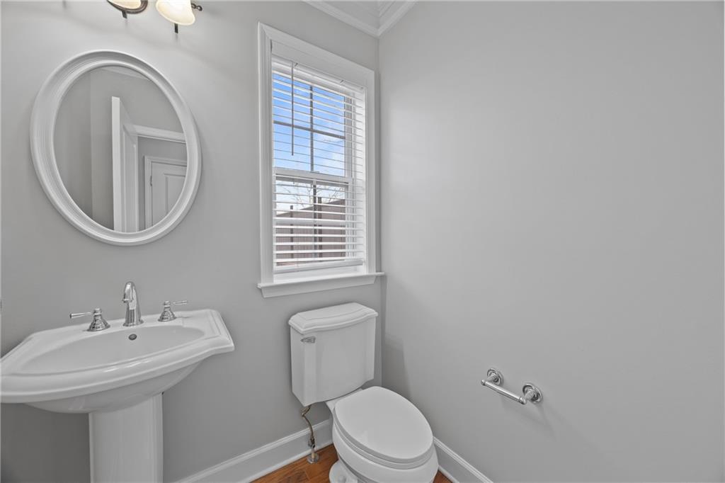 2871 Overlook Way Atlanta, GA 30324 - Photo 8 of 32 a bathroom with a toilet a sink and a mirror