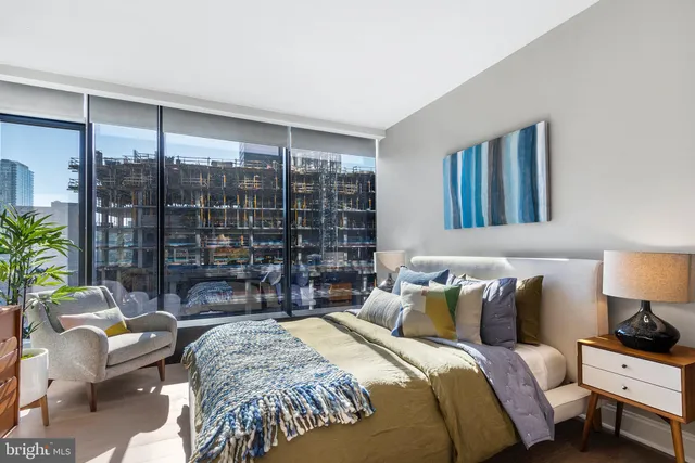 a bed room with a bed and a chair