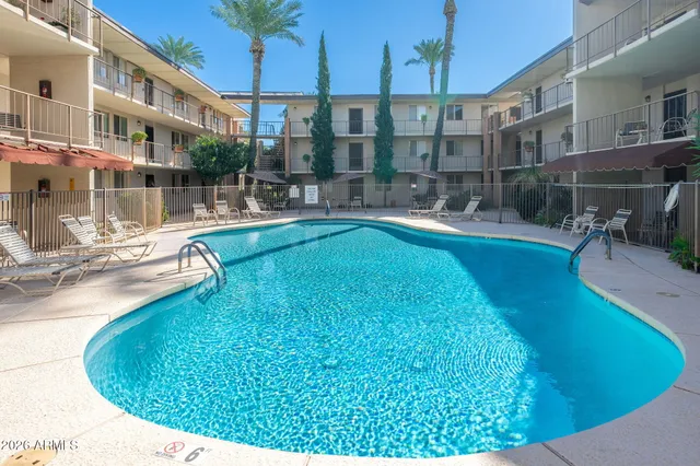 a swimming pool with outdoor seating and yard