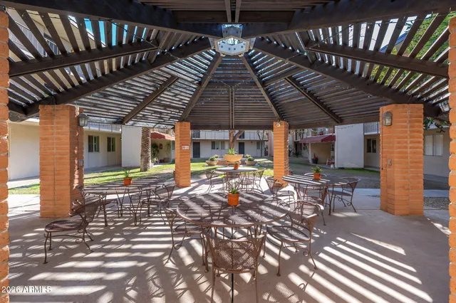 a view of a patio with table and chairs with wooden floor