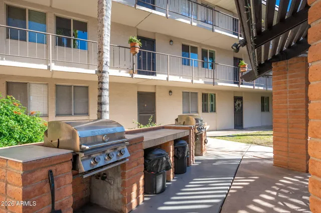 a front view of a building with a garden
