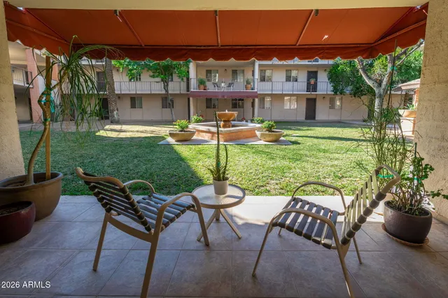 a view of a patio with a table and chairs