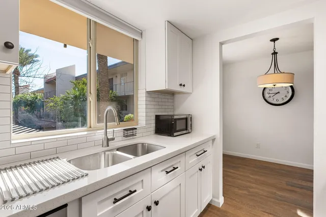 a kitchen with stainless steel appliances granite countertop a sink and a window