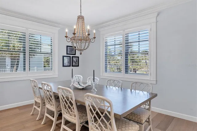 a dining room with furniture a chandelier and window