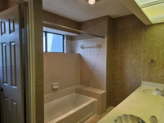 a bathroom with a tub and a shower