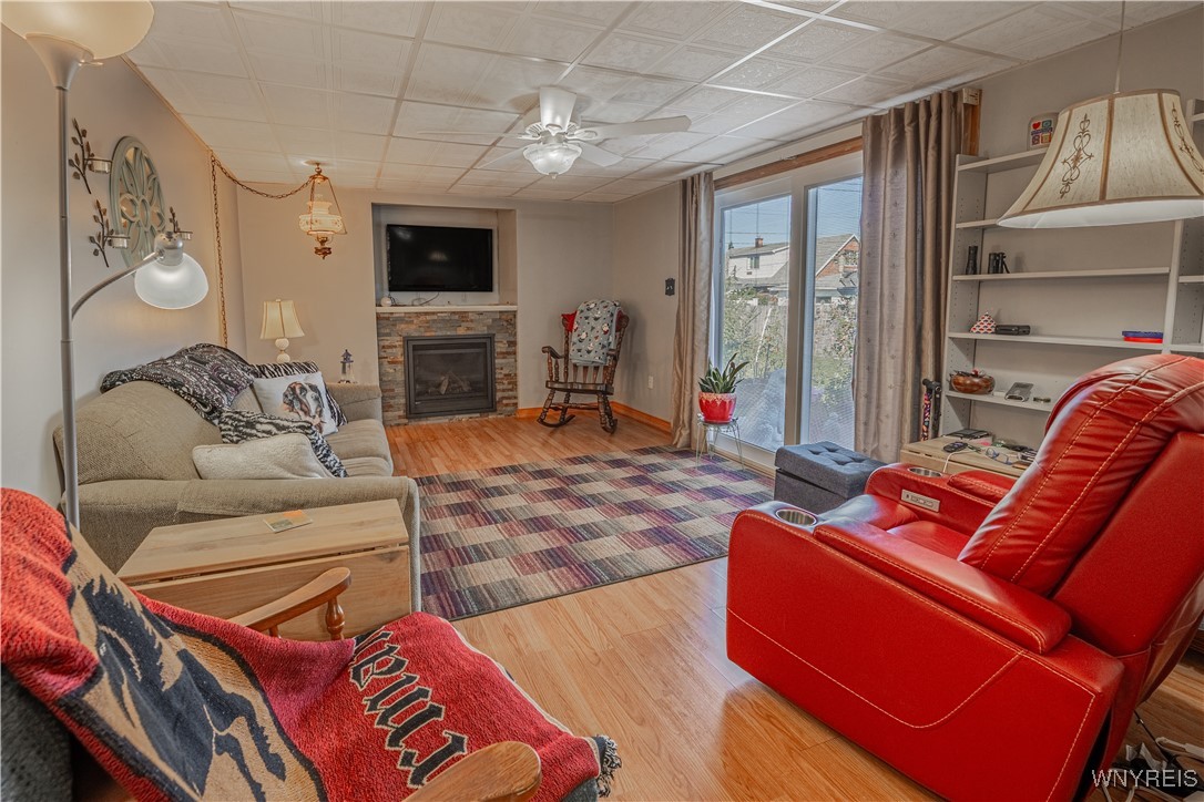 18 Louise Drive Cheektowaga, NY 14227 - Photo 10 of 41 Family room with a fireplace. Sliding glass doors