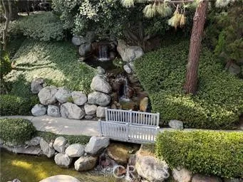 a view of a wooden house with a yard and a garden