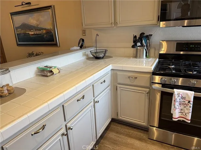 a kitchen with white cabinets and white appliances
