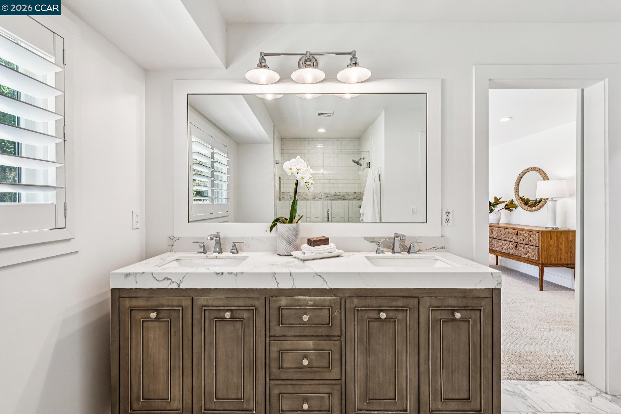 2941 Roundhill Road Alamo, CA 94507 - Photo 57 of 83 a bathroom with a double vanity sink and a mirror