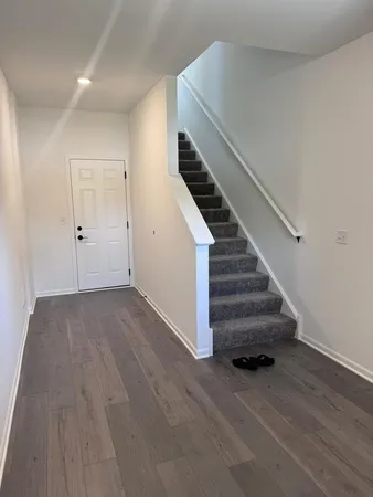 a view of entryway and hall with wooden floor