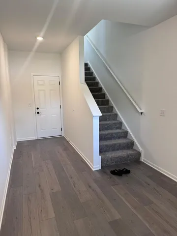 a view of entryway and hall with wooden floor