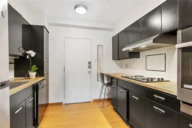 a kitchen with stainless steel appliances granite countertop a stove a refrigerator and a sink