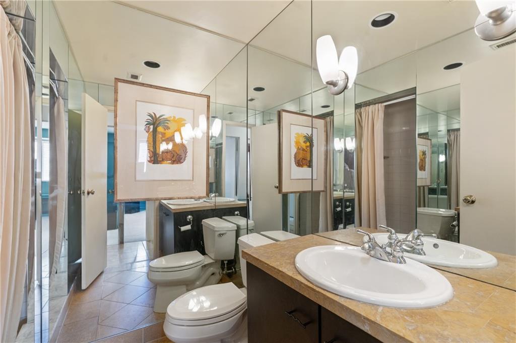 128 North Craig Street, Unit 612 Pittsburgh, PA 15213 - Photo 17 of 22 a bathroom with a sink a toilet a mirror a vanity and shower