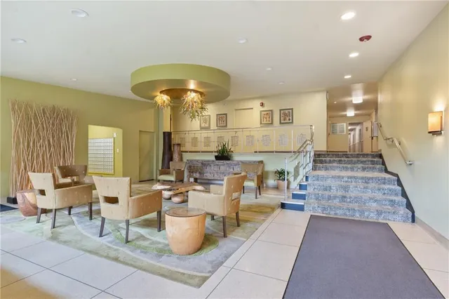 a living room with fireplace furniture and a chandelier