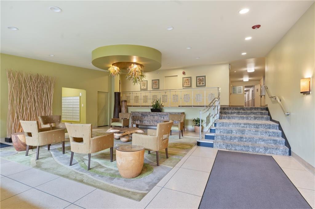 128 North Craig Street, Unit 612 Pittsburgh, PA 15213 - Photo 2 of 22 a living room with fireplace furniture and a chandelier
