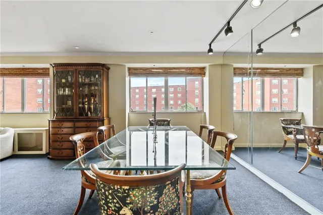 a living room with furniture a window and a chandelier