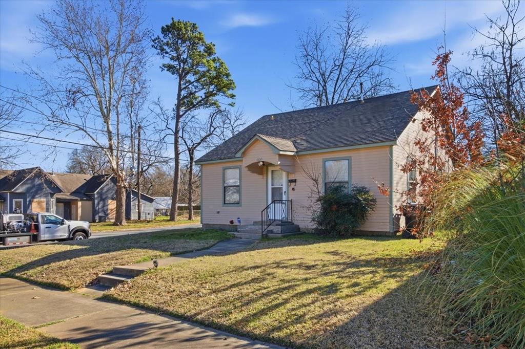 1000 West Morgan Street Denison, TX 75020 - Photo 1 of 30 View of front of house featuring a front lawn and a shingled roof