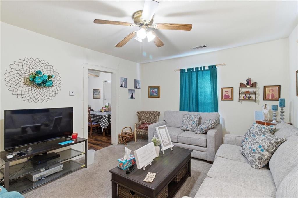 1000 West Morgan Street Denison, TX 75020 - Photo 3 of 30 Living area featuring ceiling fan and carpet