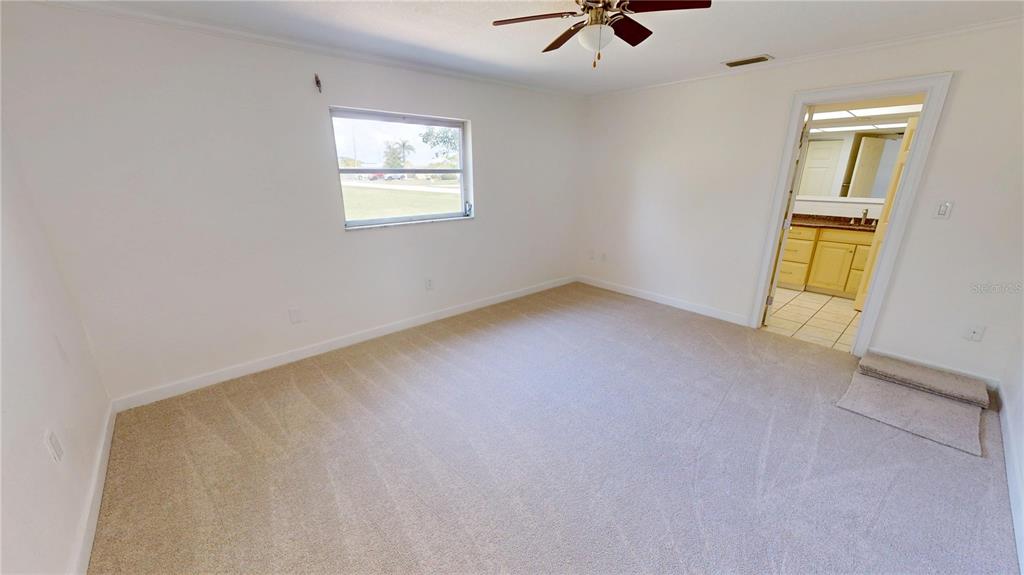 2028 River Basin Terrace Punta Gorda, FL 33982 - Photo 12 of 40 an empty room with windows and fan