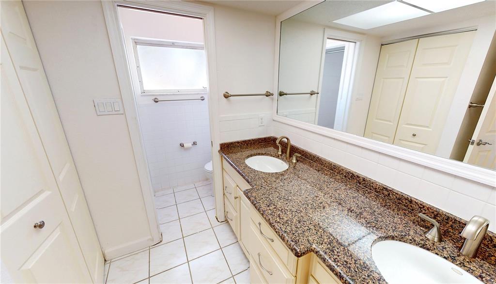2028 River Basin Terrace Punta Gorda, FL 33982 - Photo 15 of 40 a bathroom with a granite countertop sink and a mirror