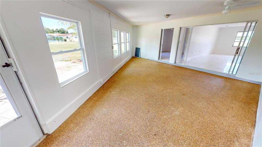 2028 River Basin Terrace Punta Gorda, FL 33982 - Photo 18 of 40 a view of an empty room with a fireplace and a window