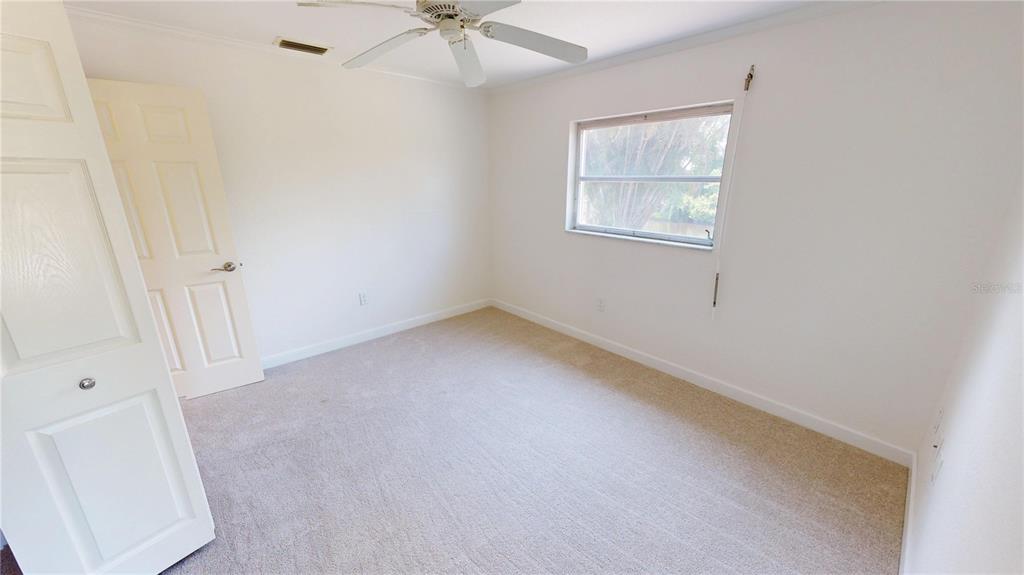 2028 River Basin Terrace Punta Gorda, FL 33982 - Photo 19 of 40 an empty room with a window and a fan