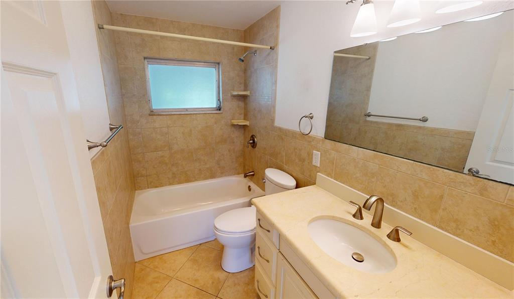 2028 River Basin Terrace Punta Gorda, FL 33982 - Photo 22 of 40 a bathroom with a sink mirror toilet and bathtub