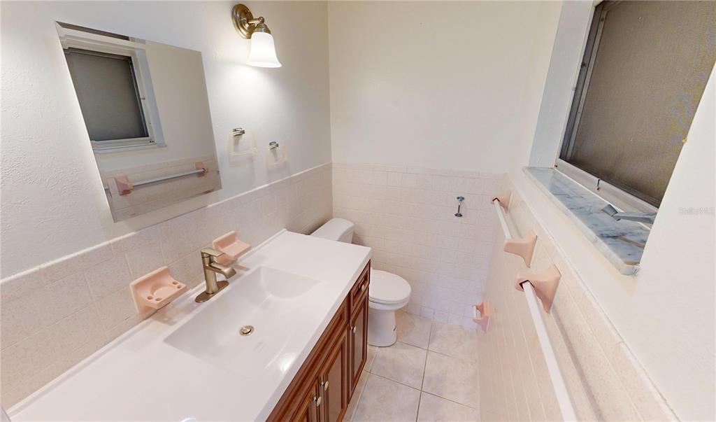 2028 River Basin Terrace Punta Gorda, FL 33982 - Photo 26 of 40 a bathroom with a sink a toilet and mirror