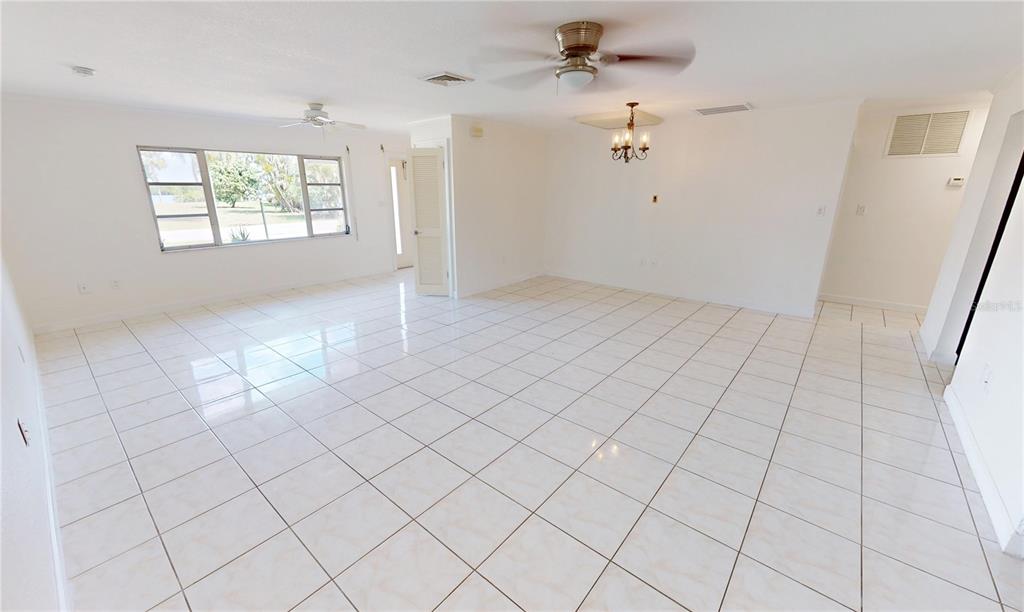 2028 River Basin Terrace Punta Gorda, FL 33982 - Photo 8 of 40 an empty room with windows and ceiling fan