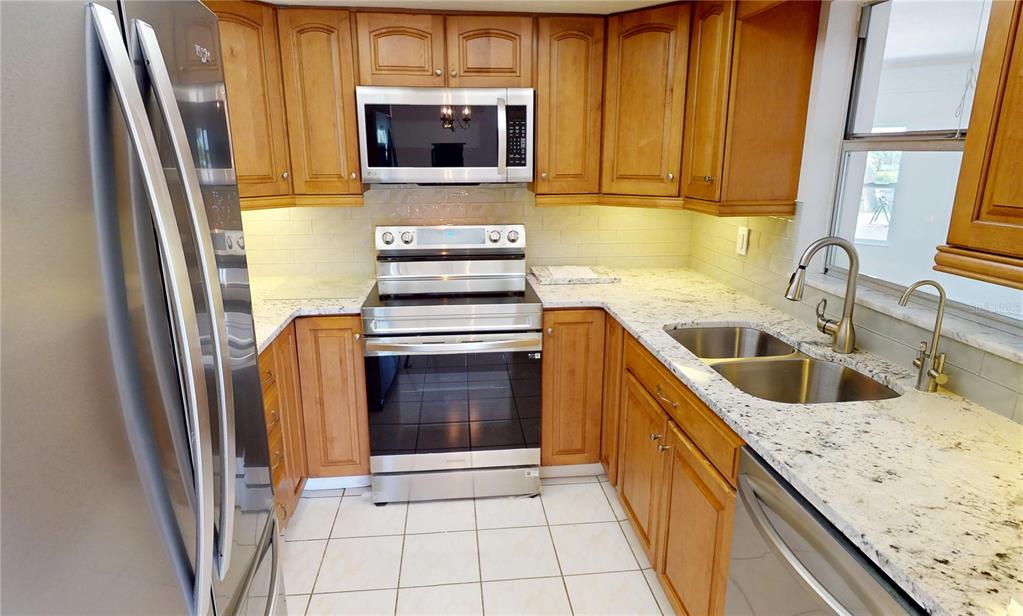 2028 River Basin Terrace Punta Gorda, FL 33982 - Photo 9 of 40 a kitchen with a sink stove and refrigerator