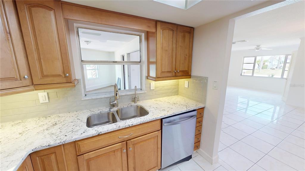 2028 River Basin Terrace Punta Gorda, FL 33982 - Photo 10 of 40 a kitchen with granite countertop a sink and a window