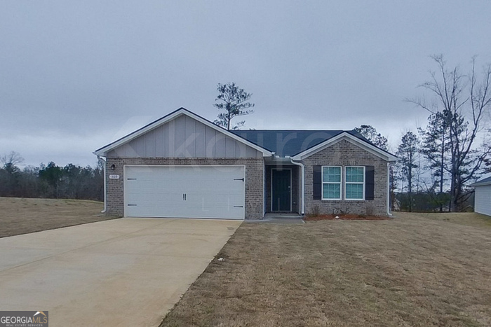 509 Pine Meadows Macon, GA 31206 - Photo 1 of 1 a front view of a house with a yard and garage
