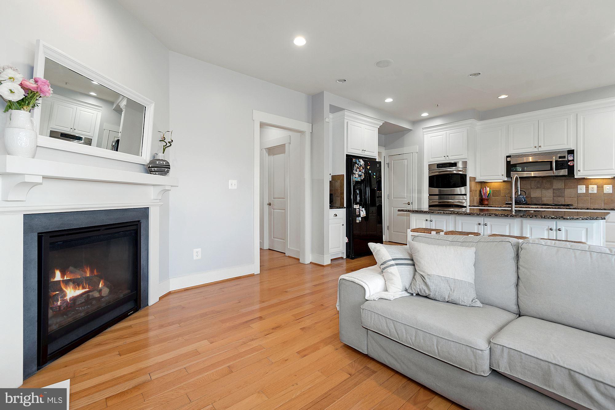 9502 Ament Street Silver Spring, MD 20910 - Photo 10 of 48 Open kitchen to family room with a gas fireplace