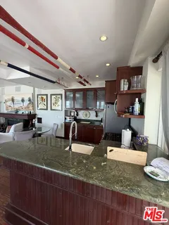a living room with lots of furniture and a kitchen view
