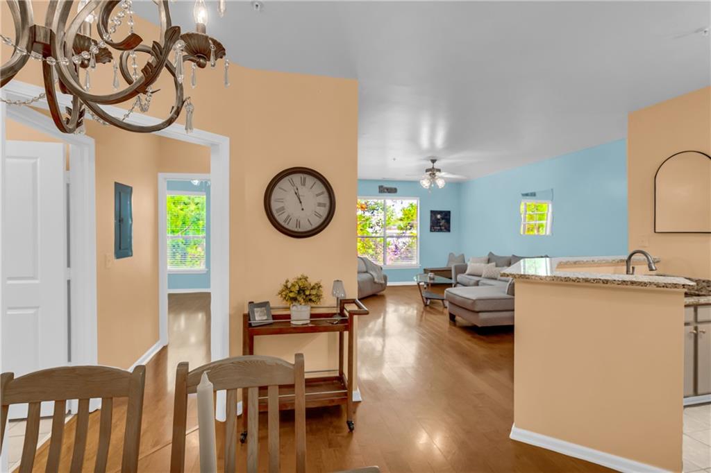 821 Ralph McGill Boulevard Northeast, Unit 2303 Atlanta, GA 30306 - Photo 25 of 43 a living room with furniture a clock on wall and a window