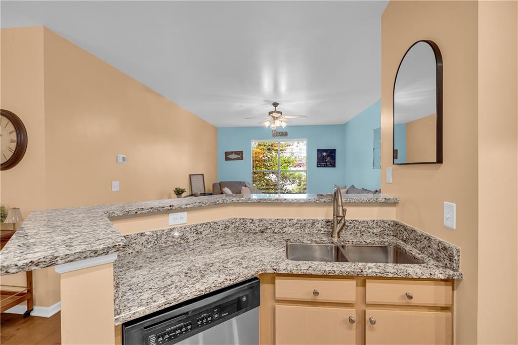 821 Ralph McGill Boulevard Northeast, Unit 2303 Atlanta, GA 30306 - Photo 9 of 43 a kitchen with granite countertop a sink stainless steel appliances and cabinets